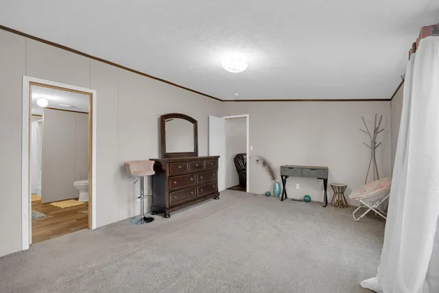 a room with a bed and a television