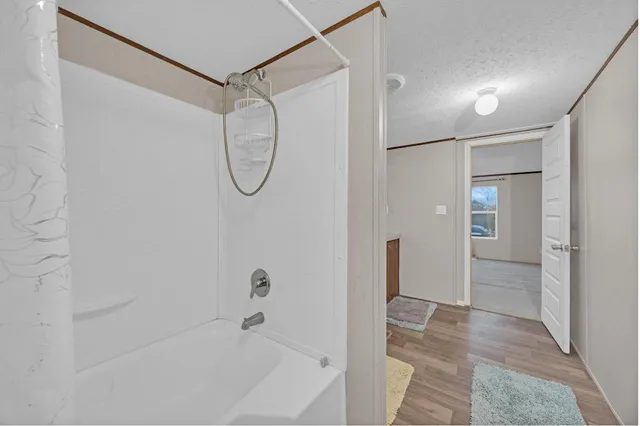 a bathroom with a bathtub and a shower