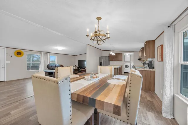 a view of a dining room with furniture and a chandelier