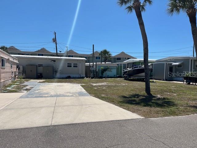 2295 North Beach Road, Unit 22 Englewood, FL 34223 - Photo 2 of 11 a front view of a house with a garden