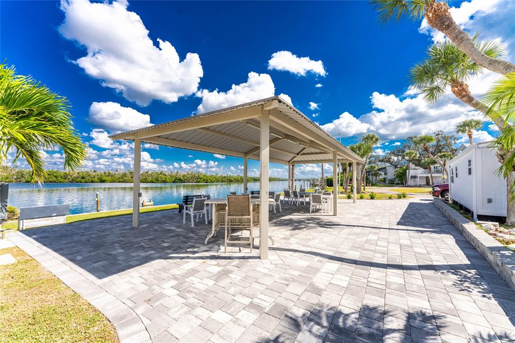 2295 North Beach Road, Unit 22 Englewood, FL 34223 - Photo 6 of 11 a view of a patio with a table and chairs under an umbrella
