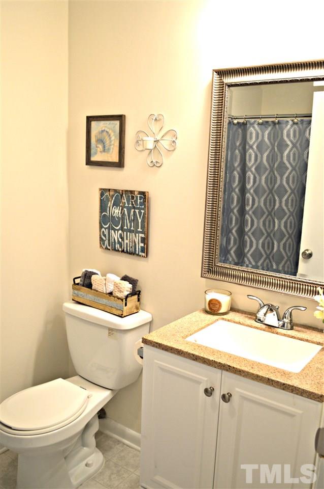 3333 Friar Tuck Road Raleigh, NC 27610 - Photo 17 of 21 a bathroom with a toilet a sink and mirror