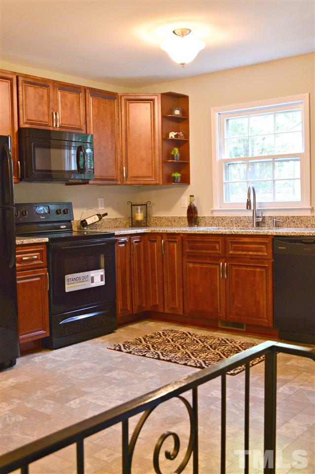 3333 Friar Tuck Road Raleigh, NC 27610 - Photo 10 of 21 a kitchen with stainless steel appliances granite countertop a stove a sink dishwasher and a refrigerator with wooden floor