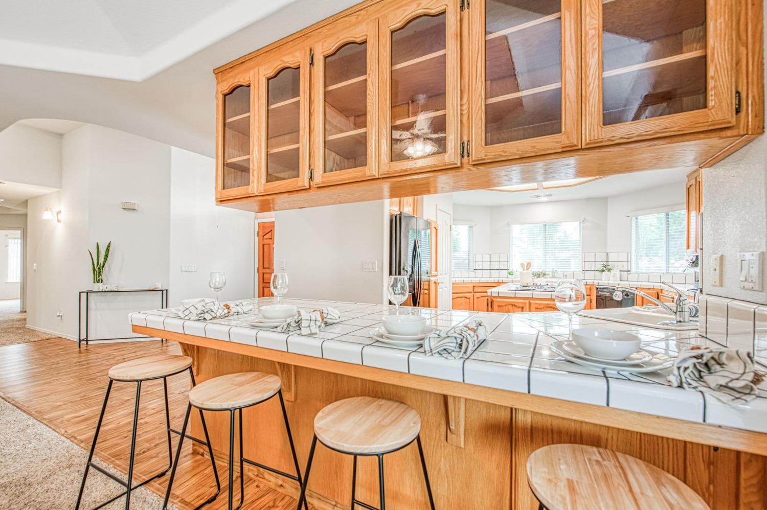 3225 Filbert Avenue Clovis, CA 93611 - Photo 12 of 36 a room with granite countertop a dining table chairs and view of living room