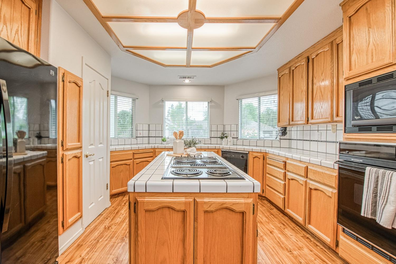 3225 Filbert Avenue Clovis, CA 93611 - Photo 15 of 36 a kitchen with stainless steel appliances granite countertop a stove and a sink
