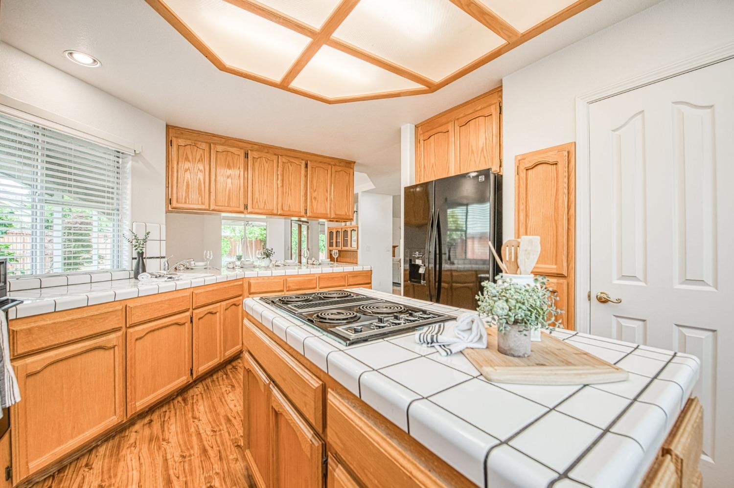 3225 Filbert Avenue Clovis, CA 93611 - Photo 16 of 36 a kitchen with stainless steel appliances granite countertop a sink a stove and a refrigerator