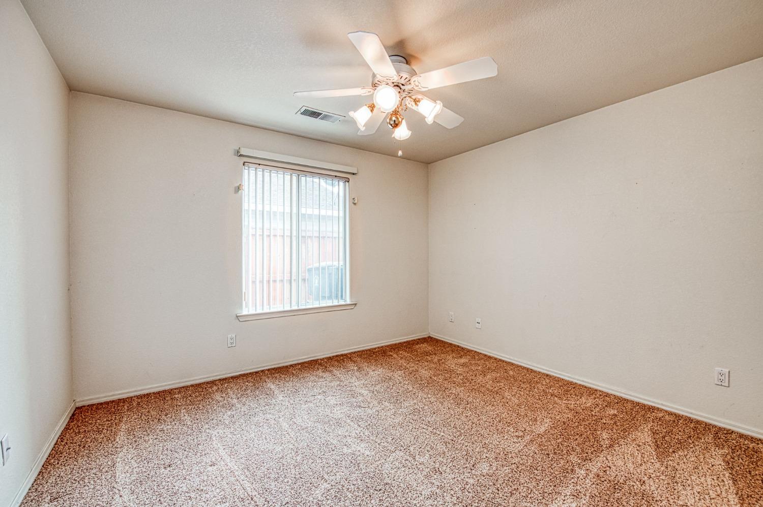 3225 Filbert Avenue Clovis, CA 93611 - Photo 20 of 36 an empty room with windows and chandelier fan