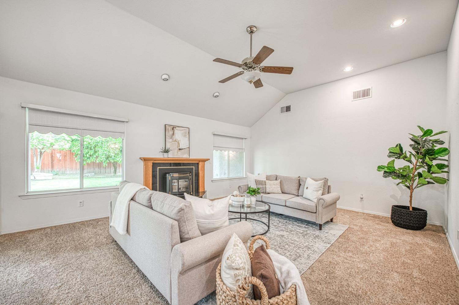 3225 Filbert Avenue Clovis, CA 93611 - Photo 5 of 36 a living room with furniture a fireplace and a potted plant