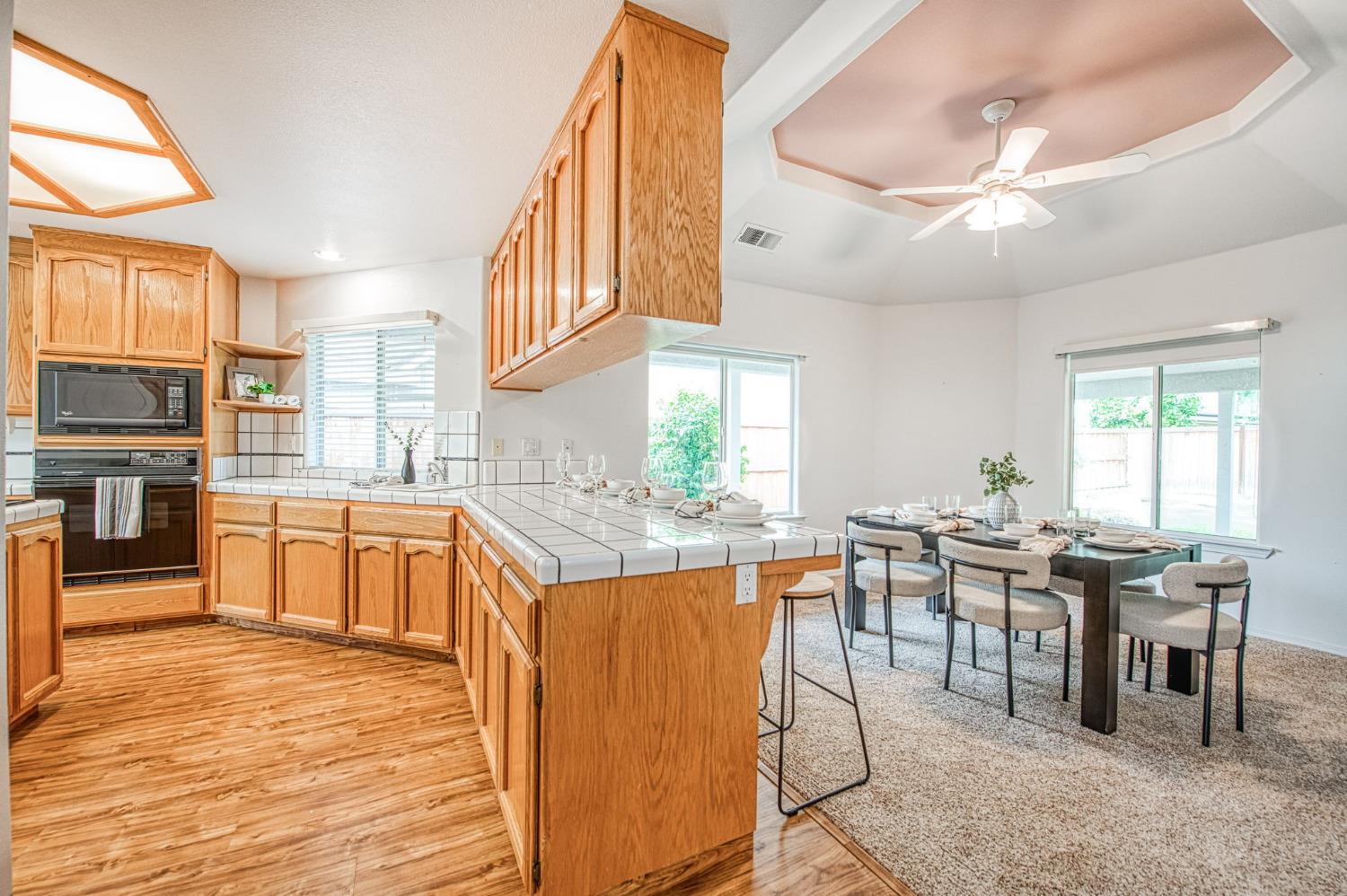 3225 Filbert Avenue Clovis, CA 93611 - Photo 9 of 36 a kitchen with lots of counter top space and dining table