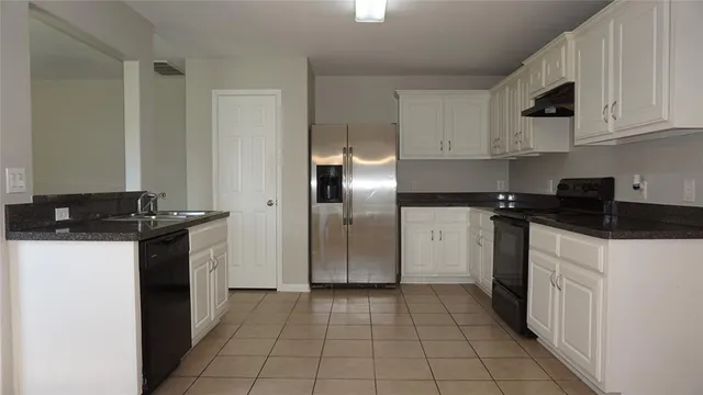 a kitchen with a sink a stove and refrigerator