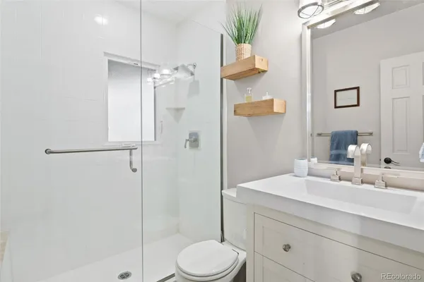 a bathroom with a sink toilet and shower