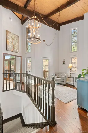 a view of a porch with wooden floor and furniture