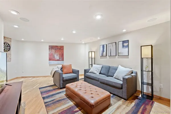 a living room with furniture and wooden floor