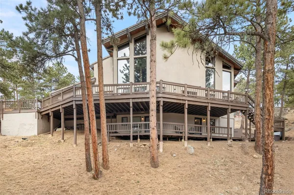 a backyard of a house with a large tree