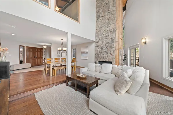 a living room with furniture wooden floor and a large window