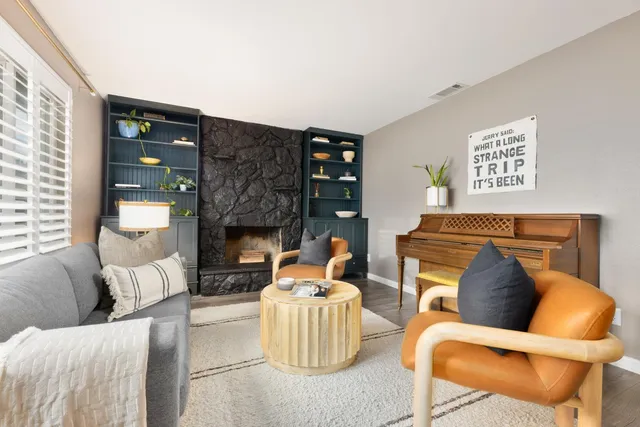 a living room with furniture and a potted plant