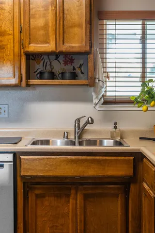 a kitchen with stainless steel appliances granite countertop a sink stove and cabinets