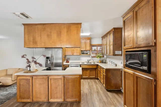 a kitchen with a sink a stove and cabinets