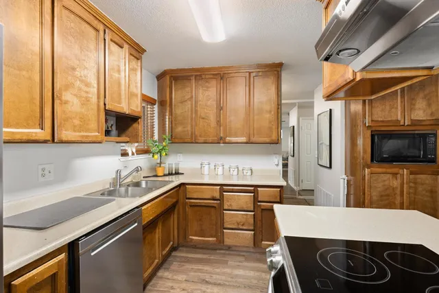 a kitchen that has a sink and a stove