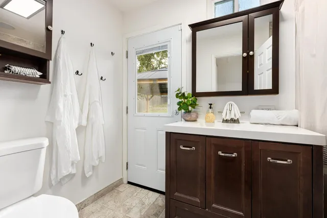 a view of a backyard with potted plants and wooden fence