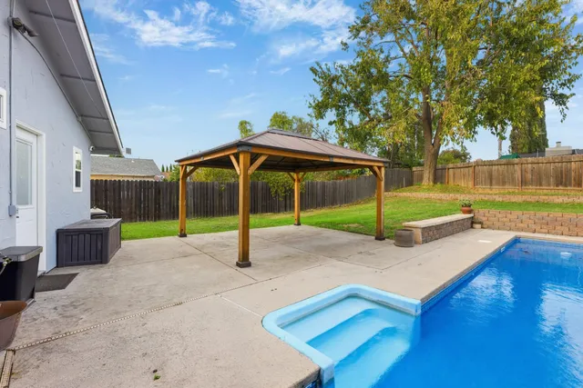 a view of swimming pool with a yard