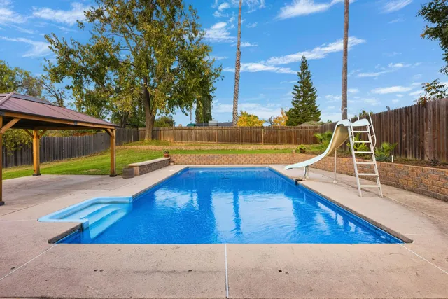 a view of a chairs and table in the patio