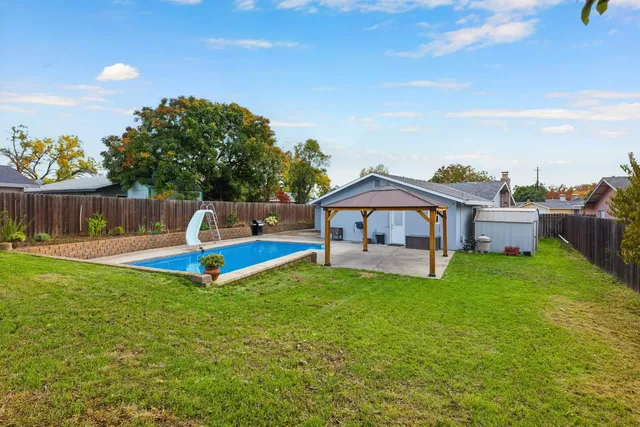 an aerial view of a house with garden space and street view