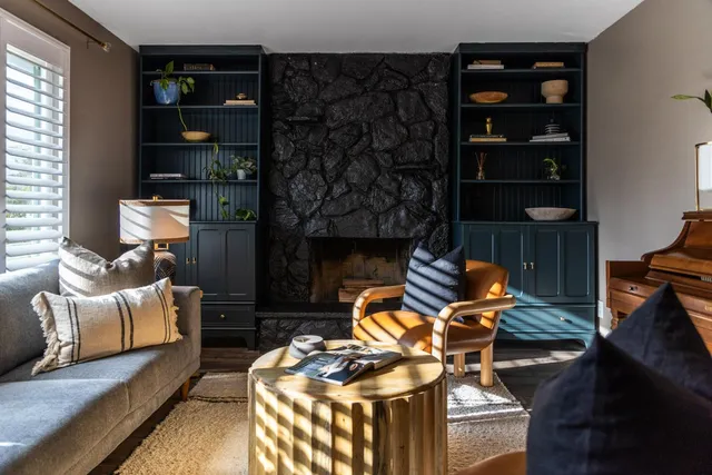 a living room with furniture a rug and a fireplace