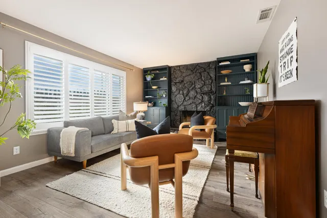 a living room with furniture and a fireplace