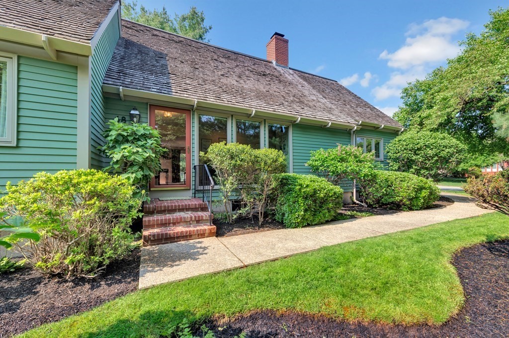 68 Potter Pond, Unit 68 Lexington, MA 02421 - Photo 1 of 28 a front view of a house with a yard and potted plants
