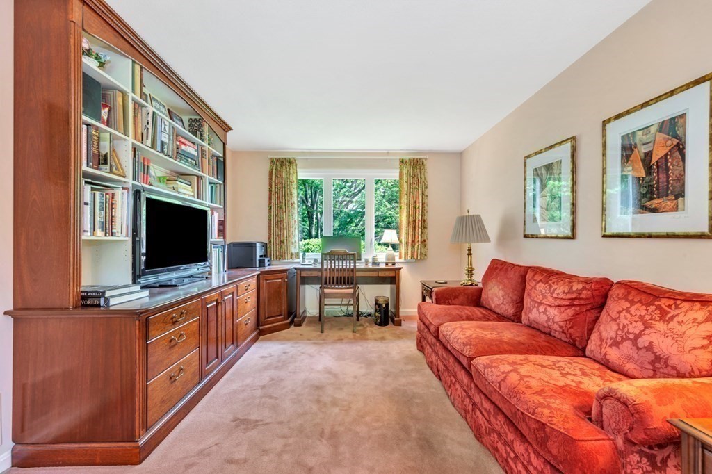 68 Potter Pond, Unit 68 Lexington, MA 02421 - Photo 13 of 28 a living room with furniture and a flat screen tv