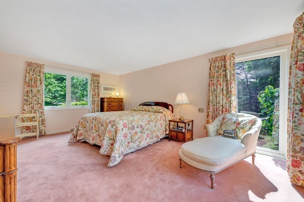 68 Potter Pond, Unit 68 Lexington, MA 02421 - Photo 14 of 28 a bedroom with a bed and a large window
