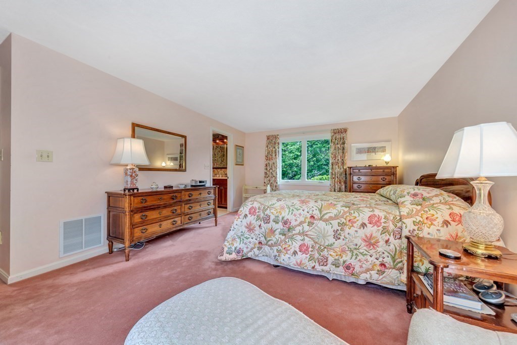 68 Potter Pond, Unit 68 Lexington, MA 02421 - Photo 16 of 28 a bedroom with a bed and a dresser in it