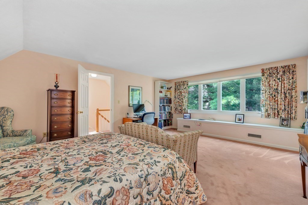 68 Potter Pond, Unit 68 Lexington, MA 02421 - Photo 20 of 28 a spacious bedroom with a large bed and a large window
