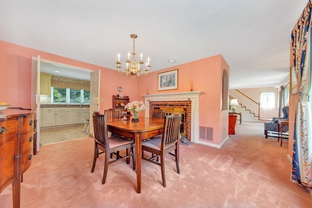 68 Potter Pond, Unit 68 Lexington, MA 02421 - Photo 5 of 28 a view of a dining room with furniture and a chandelier