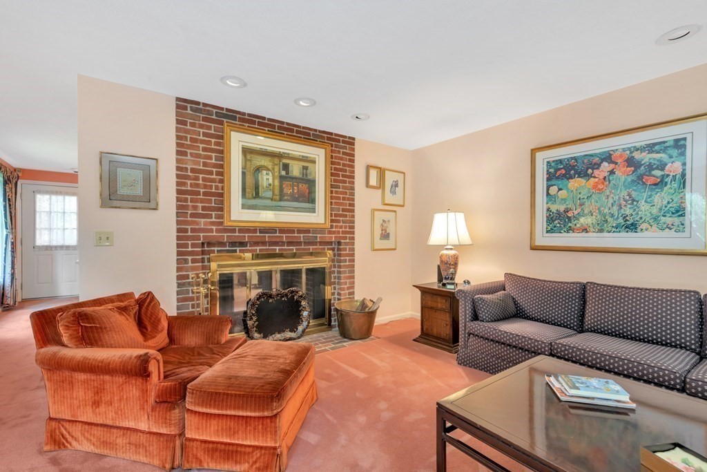 68 Potter Pond, Unit 68 Lexington, MA 02421 - Photo 9 of 28 a living room with furniture a fireplace and a flat screen tv
