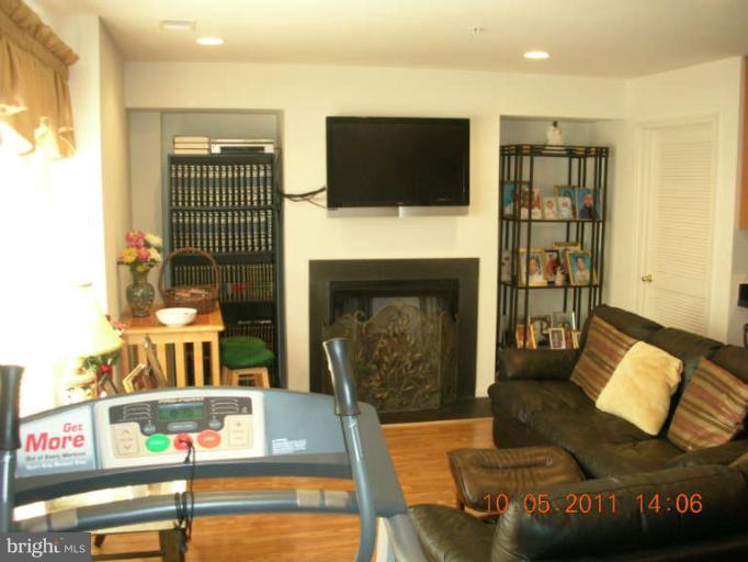9510 Coyle Road, Unit 201 Owings Mills, MD 21117 - Photo 11 of 14 a living room with furniture and a fireplace