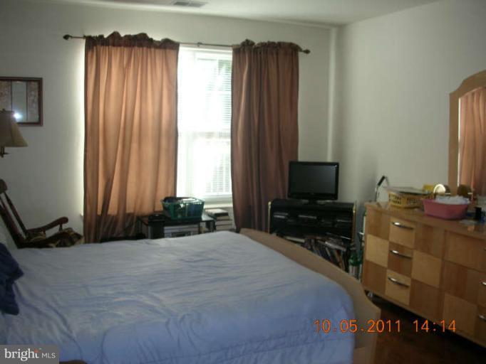 9510 Coyle Road, Unit 201 Owings Mills, MD 21117 - Photo 13 of 14 a bedroom with a bed and a window