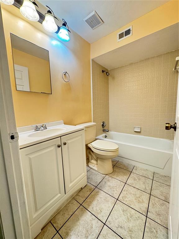 4224 Southwest 70th Terrace, Unit A Gainesville, FL 32608 - Photo 11 of 20 a bathroom with a sink a toilet and mirror
