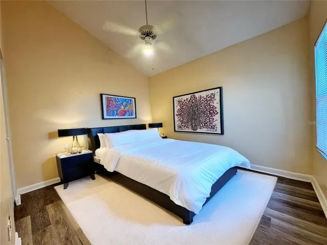 a bedroom with a large bed and a chandelier