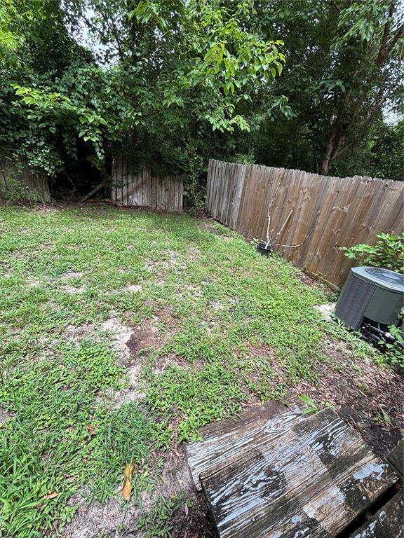 4224 Southwest 70th Terrace, Unit A Gainesville, FL 32608 - Photo 23 of 25 a backyard of a house with lots of green space