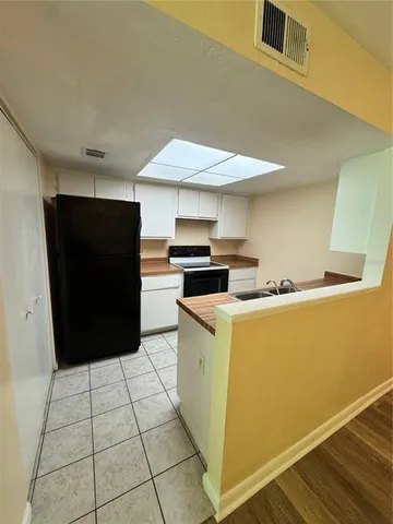 a kitchen with a cabinets and wooden floor