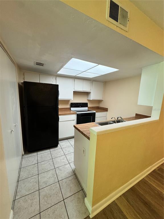 4224 Southwest 70th Terrace, Unit A Gainesville, FL 32608 - Photo 5 of 25 a kitchen with a cabinets and wooden floor