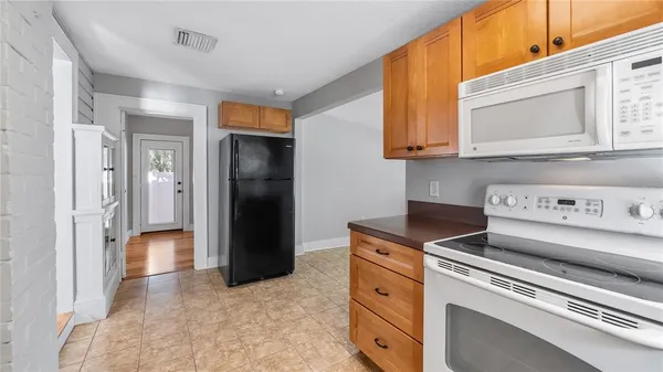 a kitchen with a stove and a refrigerator