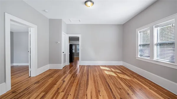 a view of a room with wooden floor and a window