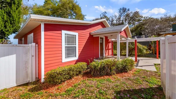 a view of a house with backyard and porch