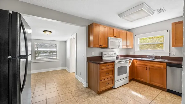 a kitchen with stainless steel appliances granite countertop a refrigerator and a sink