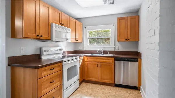 a kitchen with stainless steel appliances granite countertop a sink stove and cabinets