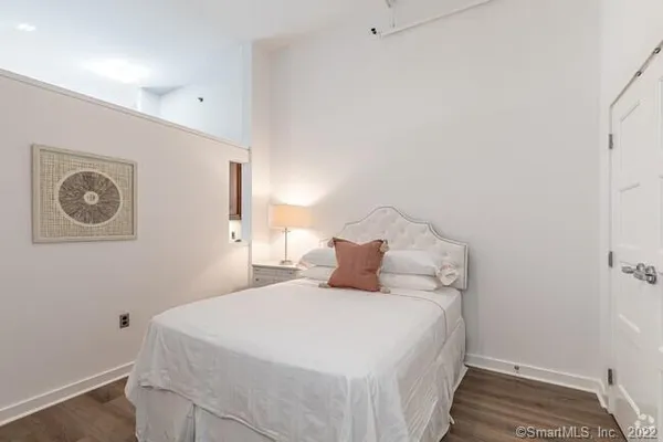 a bedroom with a bed and a lamp