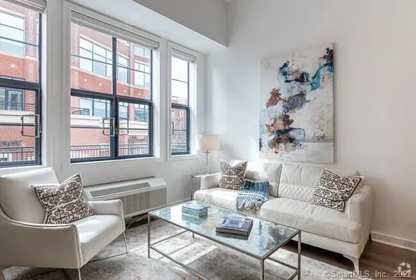 a living room with furniture and a large window